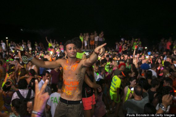 KOH PHANGAN, THAILAND - AUGUST 22: Hundreds of full moon partiers dance the night away on the beach of Haad Rin on August 22, 2013 in Koh Phangan, Thailand.  Thousands of people from around the world pack the Haad Rin beach enjoying the cheap liquor, drugs engaging in an all night affair. The full moon party started in late 1988 and has become one of the biggest tourist attractions for young backpackers in love with the all night beach party. It is also a huge money making venture for locals both on Koh Phangan and Koh Samui. (Photo by Paula Bronstein/Getty Images)